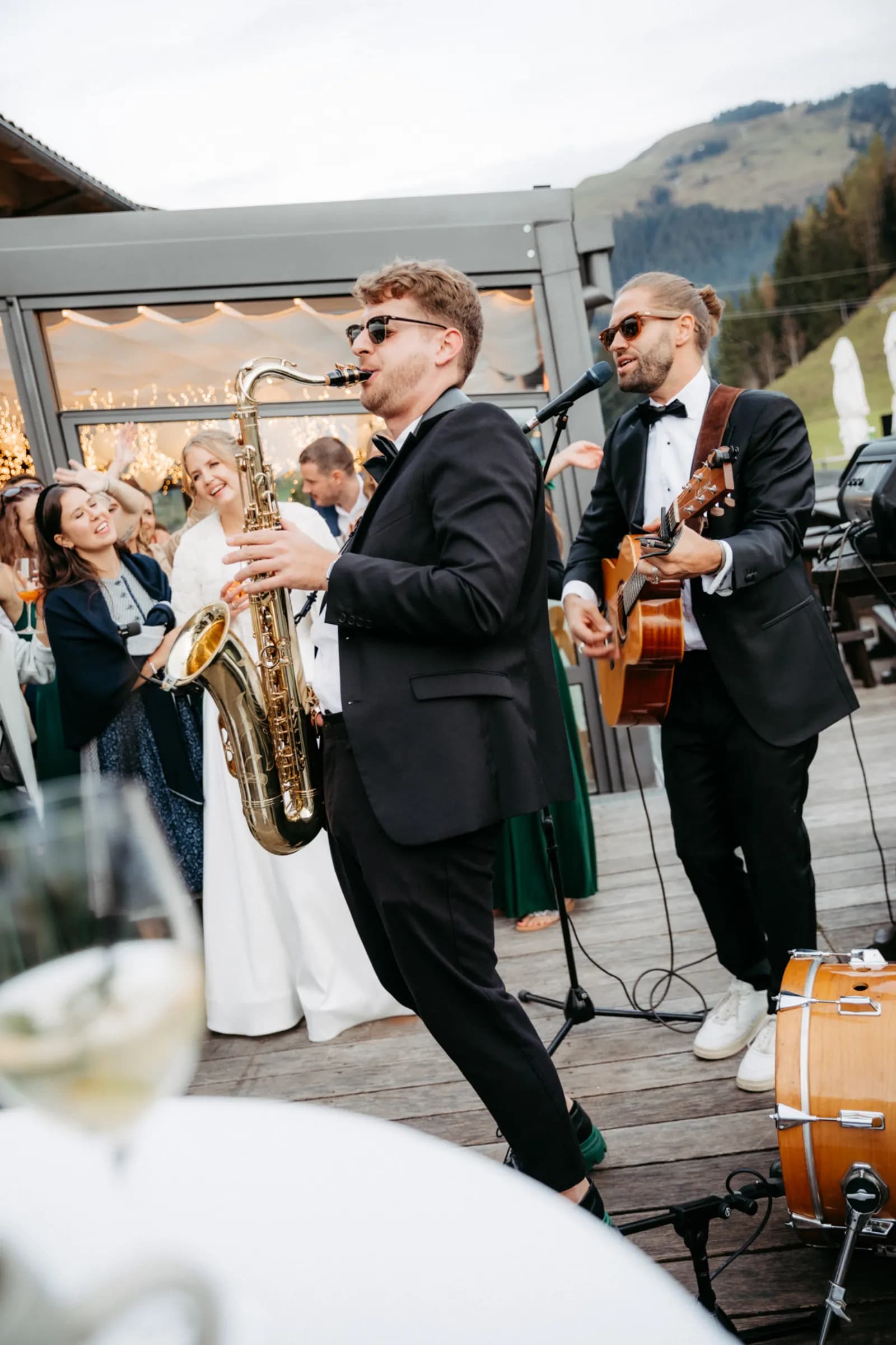 Pascal playing saxophone with band at a mountain wedding